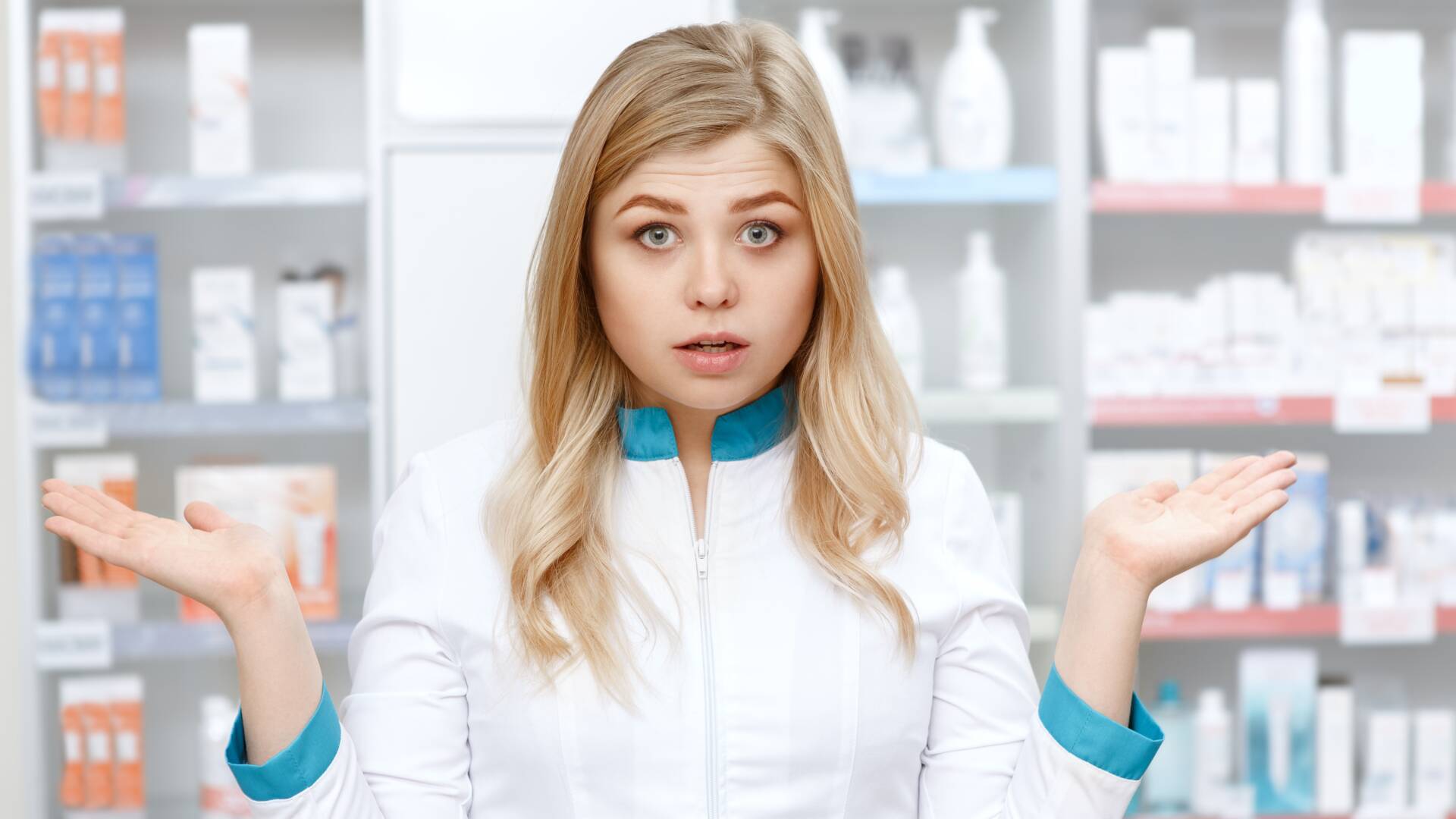 Confused female pharmacist posing at the drugstore
